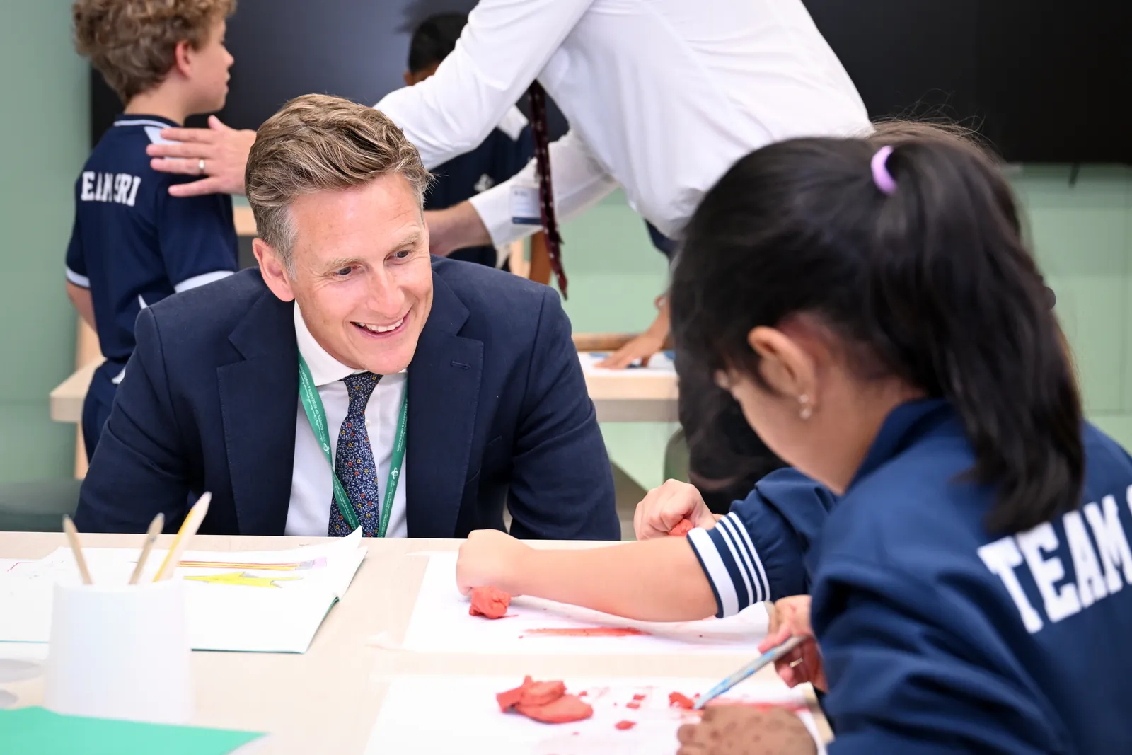 Incoming Principal Richard Jones smiling with a student during a hands-on classroom activity at GEMS School of Research and Innovation